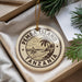 A decorative ornament with the text "PEMBA ISLAND TANZANIA" printed on it, surrounded by a tropical landscape illustration.