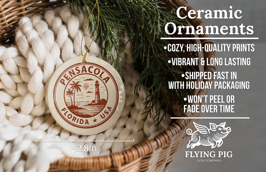 Ceramic ornaments, including a Florida ornaments, are displayed in a basket with pine branches.