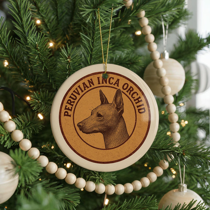 A Christmas tree decorated with ornaments, including a circular ornament with a Peruvian Inca orchid design and a beaded ornament.