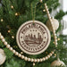 A circular ornament on a Christmas tree, featuring the text "PHILADELPHIA PENNSYLVANIA USA" and an illustration of the Philadelphia skyline.
