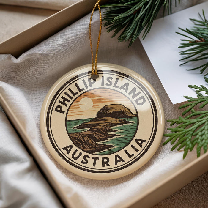 A round ornament with the text "PHILLIP ISLAND AUSTRALIA" printed on it, hanging from a string.