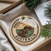 A round ornament with the text "PHILLIP ISLAND AUSTRALIA" printed on it, hanging from a string.