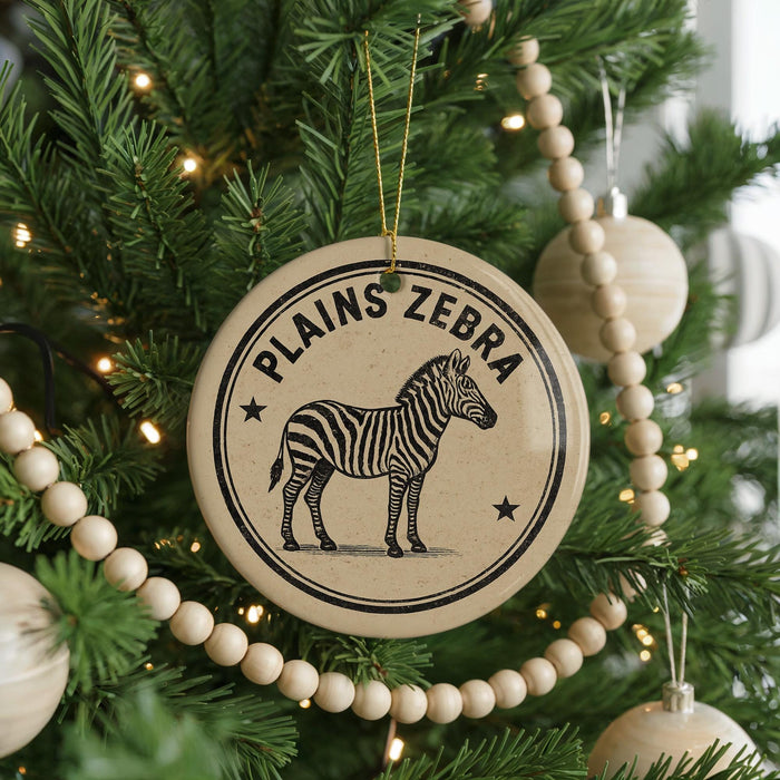 A Christmas tree decorated with ornaments, including a circular ornament with a zebra illustration and the text "PLANS ZEBRA" on it.