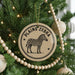 A Christmas tree decorated with ornaments, including a circular ornament with a zebra illustration and the text "PLANS ZEBRA" on it.