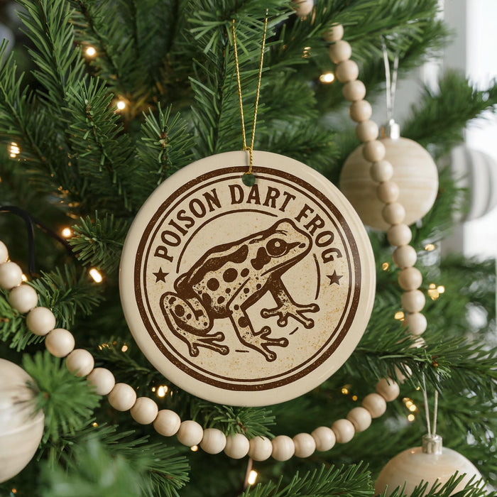 A round ornament on a Christmas tree featuring a cartoon image of a Poison Dart Frog.