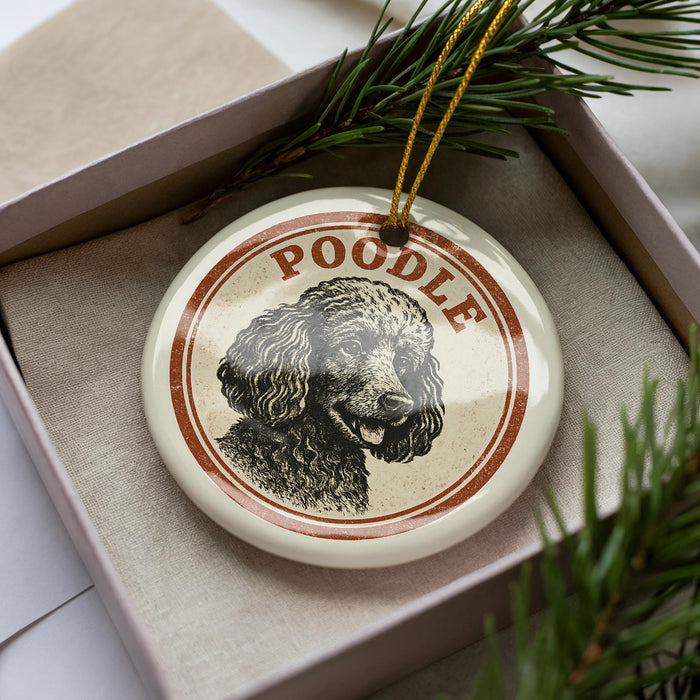 A decorative ornament featuring a poodle's portrait, with the word "Poodle" written around the edge of the circular design.