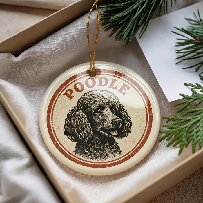 A round ornament with a poodle image and the word "Poodle" written on it, hanging from a string.