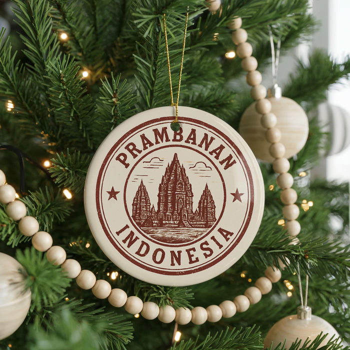A Christmas tree decorated with ornaments, including a circular ornament with the text "Prambanan Indonesia" and a castle illustration.