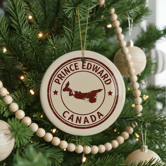 A Christmas tree decorated with ornaments, including a circular ornament with the text "PRINCE EDWARD CANADA" and a silhouette of a deer.