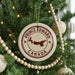 A Christmas tree decorated with ornaments, including a circular ornament with the text "PRINCE EDWARD CANADA" and a silhouette of a deer.