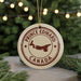 A circular ornament with the text "PRINCE EDWARD CANADA" and a map of Prince Edward Island, Canada, is displayed in front of a blurred Christmas tree with twinkling lights.