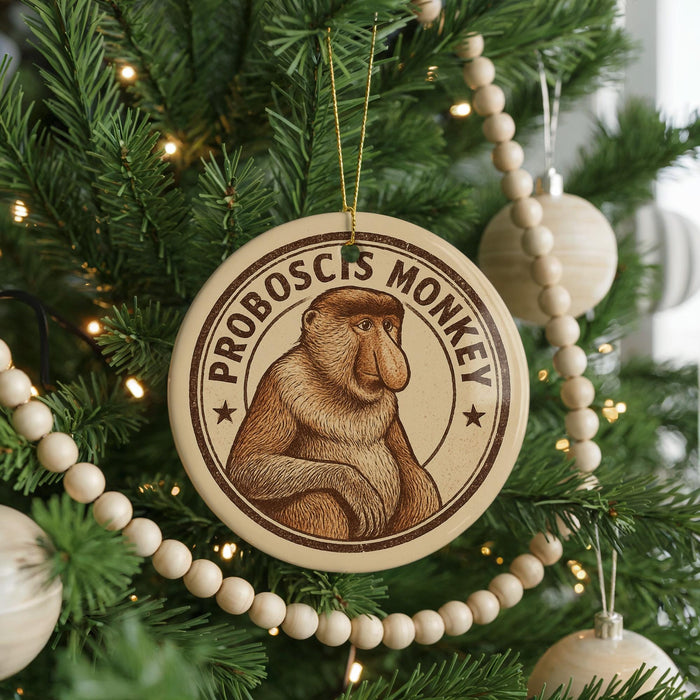A round ornament on a Christmas tree featuring a monkey, with the text "PROBOSCIS MONKEY" around the edge.