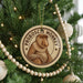 A round ornament on a Christmas tree featuring a monkey, with the text "PROBOSCIS MONKEY" around the edge.