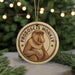 A round ornament featuring a monkey with the text "PROBOSCIIS MONKEY" on it, hanging from a string.