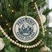 A Christmas tree decorated with ornaments, including a circular ornament with the text "PROVIDENCE RHODE ISLAND" and a cityscape design.