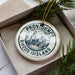 A decorative ornament with the text "PROVIDENCE RHODE ISLAND" on it, surrounded by pine branches.