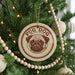 A Christmas tree decorated with ornaments, including a circular ornament with a pug dog image and the word "PUG" written on it.