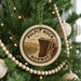 A circular ornament on a Christmas tree, featuring a scenic image of Pulpit Rock in Norway.