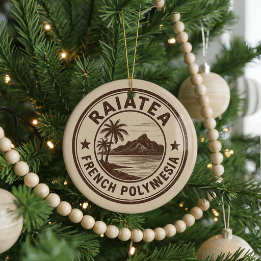 A round ornament on a Christmas tree, featuring the text "RAIATEA FRENCH POLYNESIA" and a palm tree illustration.