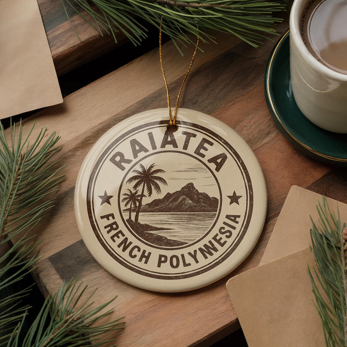 A circular ornament with the text "RAIATEA FRENCH POLYNESIA" printed on it, surrounded by pine branches and a cup of coffee on a wooden surface.