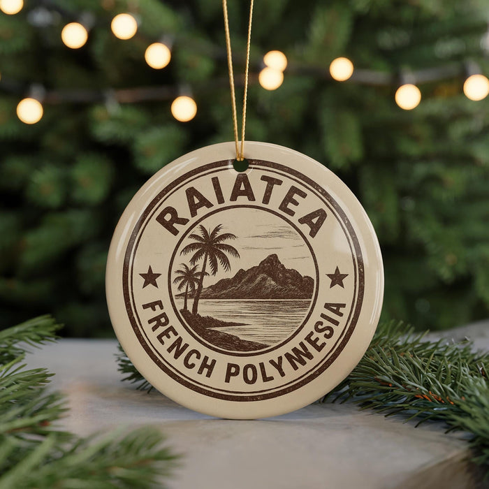 A circular ornament with the text "RAIATEA FRENCH POLYNESIA" printed on it, surrounded by a palm tree and a mountain landscape.