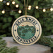 A circular ornament with the text "RAJA AMPAT INDONESIA" and an illustration of a tropical island landscape.