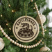 A Christmas tree decorated with ornaments, including a round ornament with a snake design and the text "Rattlesnake" on it.