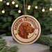 A circular ornament featuring a brown dog's head, with the text "REDBONE COONHOUND" around the edge.