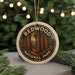 A circular ornament with the text "REDWOOD NATIONAL PARK USA" and an illustration of a forest with tall trees, hanging from a string.