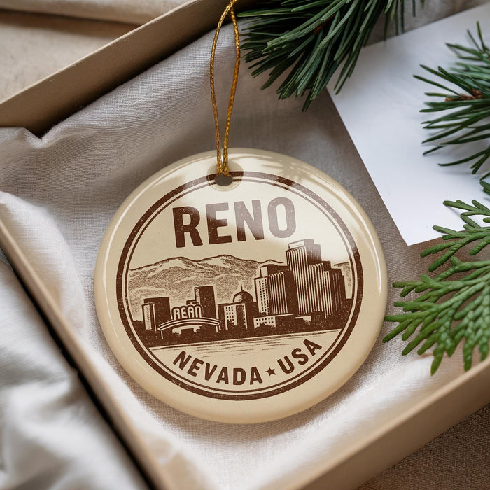 A circular ornament with the text " Reno Nevada + USA" printed on it, hanging from a string.