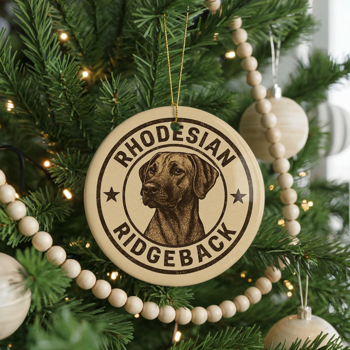 A round ornament on a Christmas tree featuring a rhodesian ridgeback dog.