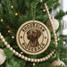 A round ornament on a Christmas tree featuring a rhodesian ridgeback dog.