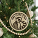 A Christmas tree decorated with ornaments, including a circular ornament featuring a lemur and the text "RING-TAILED LEMUR".