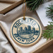 A decorative ornament with the text "Rochester New York" and a cityscape illustration, hanging from a string.