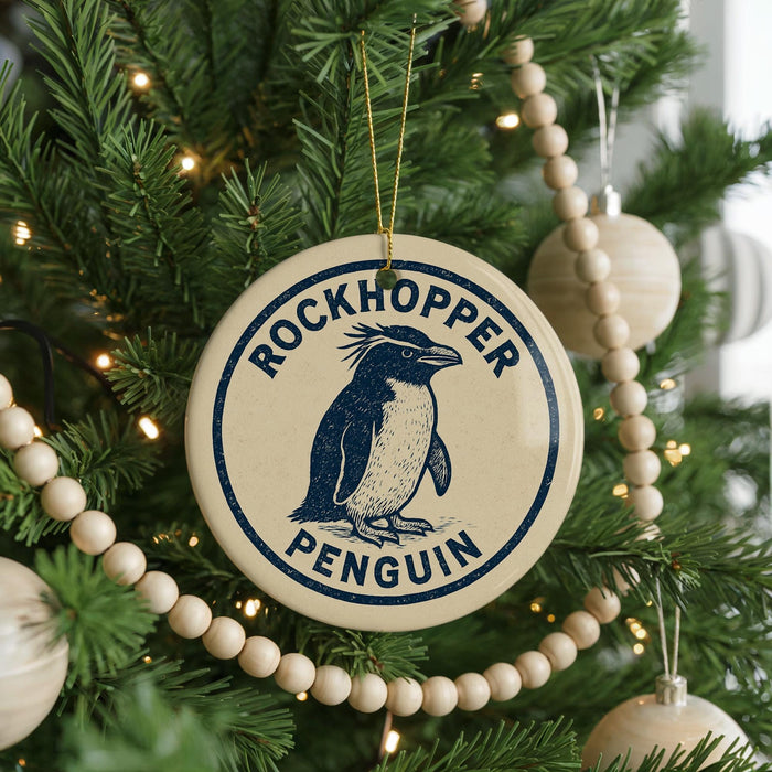 A round ornament on a Christmas tree featuring a penguin design, with the text "ROCKHOPPER PENGUIN" around the edge.