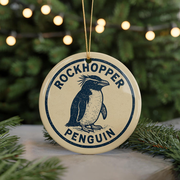 A round ornament with a penguin design, featuring the text "ROCKHOPPER PENGUIN" on it, is hanging from a string.
