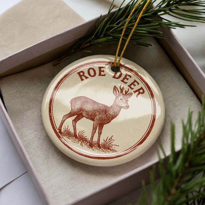 A decorative ornament in a box, featuring a deer illustration and the text "ROE DEER".