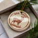 A decorative ornament in a box, featuring a deer illustration and the text "ROE DEER".