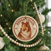 A Christmas tree decorated with ornaments, including a circular ornament with a collie image and the text "ROUGH COLLIE" on it.
