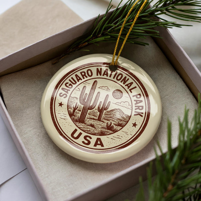 A circular ornament with the text "Sagua National Park USA" printed on it, surrounded by a decorative border and a cactus design.