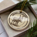 A decorative ornament featuring a detailed illustration of a goat or antelope, with the text "SAIGA ANTELOPE" around the edge.