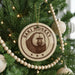 A Christmas tree decorated with ornaments, including a circular ornament with a monkey image and the text "SAKI MONKEY" on it.