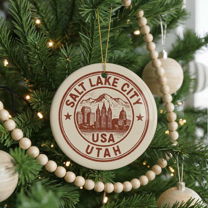 A Christmas tree decorated with ornaments, including a circular ornament with the text "Salt Lake City, USA, Utah" printed on it.