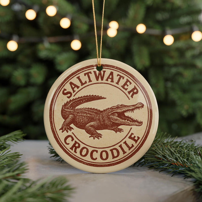 A circular ornament with the text "Saltwater Crocodile" printed on it, featuring an illustration of a crocodile.