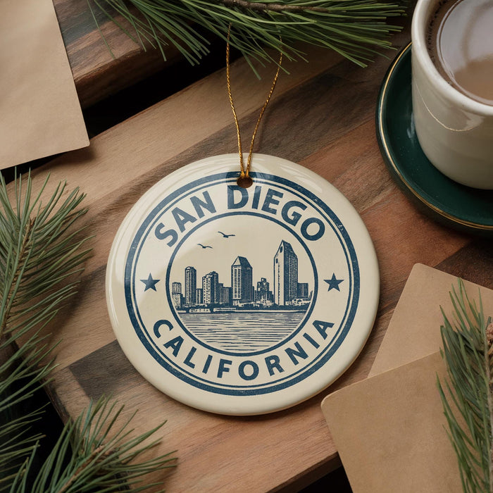 A decorative ornament with the text "SAN DIEGO CALIFORNIA" and a cityscape illustration, hanging on a wooden surface.