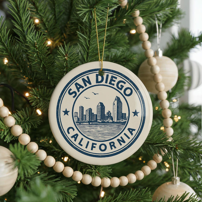 A decorative ornament on a Christmas tree, featuring a circular design with the text "SAN DIEGO CALIFORNIA" and a cityscape illustration.