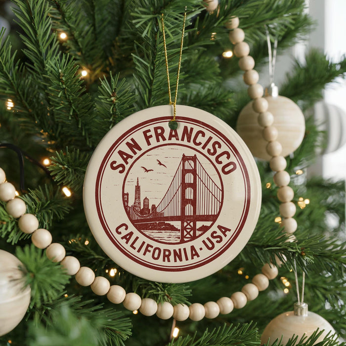 A round ornament on a Christmas tree, featuring the Golden Gate Bridge and the text "SAN FRANCISCO CALIFORNIA USA".