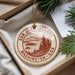 A circular ornament with the text "SAN JUAN ISLANDS WASHINGTON U.S.A." printed on it, hanging from a string.