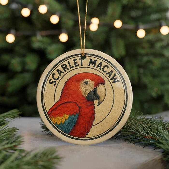 A round ornament featuring a red parrot, with the text "SCARLET MACAW" around the bird's head.