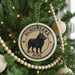 A Christmas tree decorated with ornaments, including a circular ornament with a black dog image and the text "SCHIPPERKE DOG" around the edge.